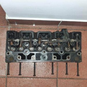Used diesel engine cylinder head for Tata Xenon displayed front and side view.Used diesel engine cylinder head