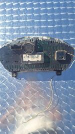 Dashboard instrument cluster showing speedometer and fuel gauge, top-down angled view.Dashboard instrument clu