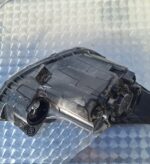 Left side headlight assembly for Hyundai Grand i10 shown from front angle with clear lens and reflector detail