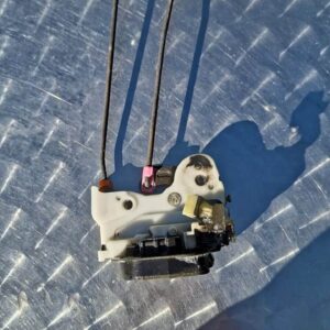 Used car door lock mechanism shown from the front with visible mounting points and latch components.Used car d