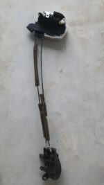Close-up of a black car door lock mechanism viewed from the side, showing the latch and mounting points.Close-