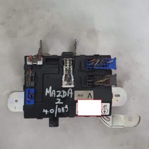 Used fusebox unit for 2009 Mazda 2 shown from front angle with visible wiring and connectors.Used fusebox unit