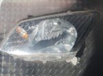 Front-facing left headlight for Isuzu Kb, clean and intact, shown against a bright background.Front-facing lef