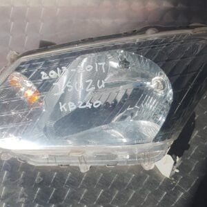 Front-facing left headlight for Isuzu Kb, clean and intact, shown against a bright background.Front-facing lef