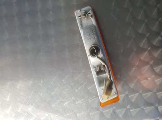 Left corner light for Toyota Conquest shown from a slight angle highlighting the clear lens and amber reflecto