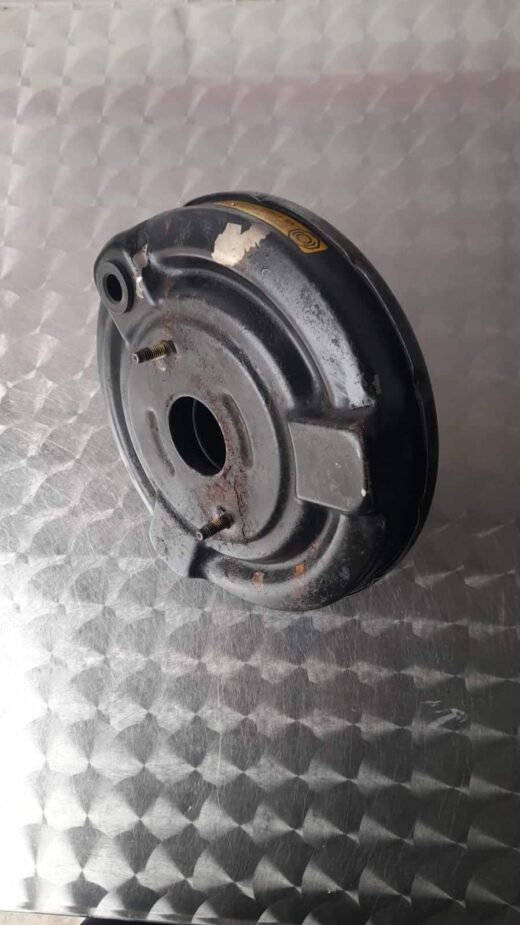 Front angled view of a Ford Ka brake booster showing the master cylinder attachment area.Front angled view of
