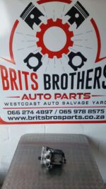Used ABS pump for Mercedes W202 shown from side angle on white background.Used ABS pump for Mercedes W202 show