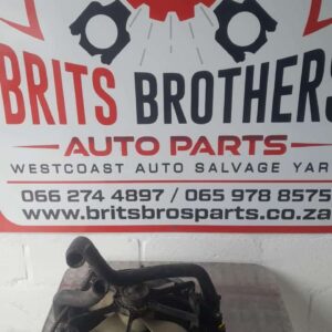 Front angled view of a car radiator cooling fan assembly with shroud, clean and intact.Front angled view of a