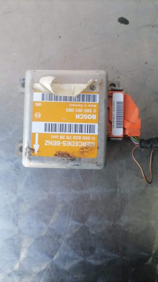 Used electronic control module for Mercedes W202 shown from front angled view with wiring harness attached.Use
