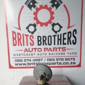 Front-facing view of a Mercedes W202 brake booster showing the round housing and mounting points.Front-facing