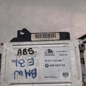 Top view of a rectangular automotive ABS module for BMW E36, showing connector ports and mounting points.Top v