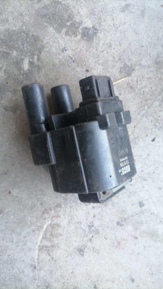 Used Renault Megane 1600 coil spring viewed from side showing full coil shape and mounting points.Used Renault