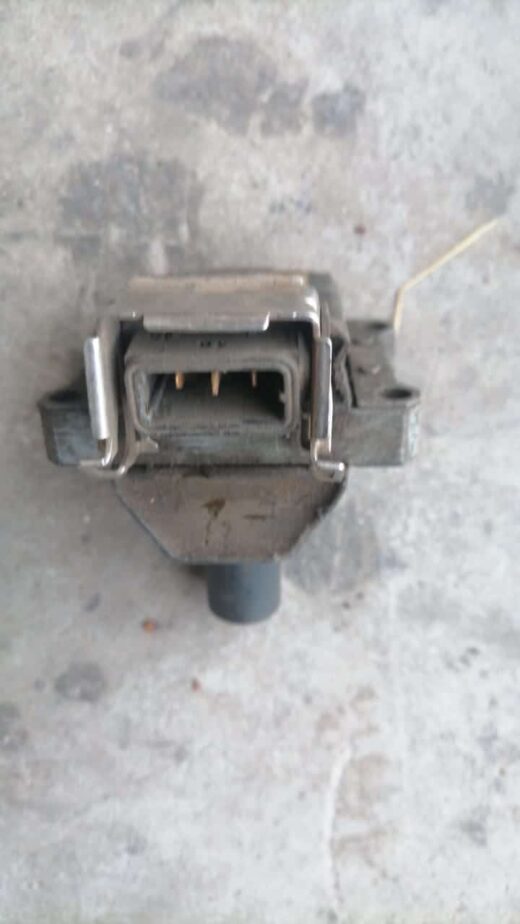 Front angled view of a black VW coil with visible electrical connectors.Front angled view of a black VW coil w