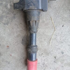 Close-up of a cylindrical pencil coil for a vehicle ignition system, angled slightly from above.Close-up of a