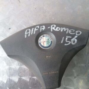 Front view of a black Alfa 156 steering wheel airbag module with centre emblem visible.Front view of a black A