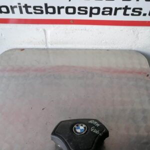 Front view of a BMW steering airbag module centered on a white background.Front view of a BMW steering airbag