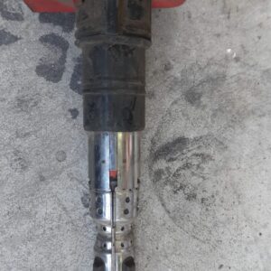 Close-up of a single ignition coil for Audi S4 displayed upright on a plain background.Close-up of a single ig