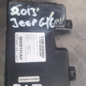 Front-facing view of a used Jeep Grand Cherokee body control unit with wiring harness attached.Front-facing vi