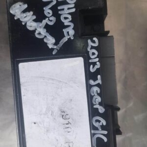Front view of a Jeep Grand Cherokee phone module showing connectors and mounting points.Front view of a Jeep G