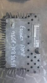 Front view of Ford Escort car amplifier showing connectors and mounting points on a plain background.Front vie