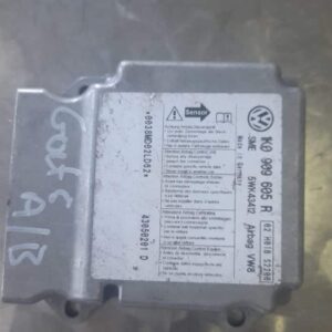 Top view of a VW Golf 5 airbag control module showing connector ports and metal casing.Top view of a VW Golf 5