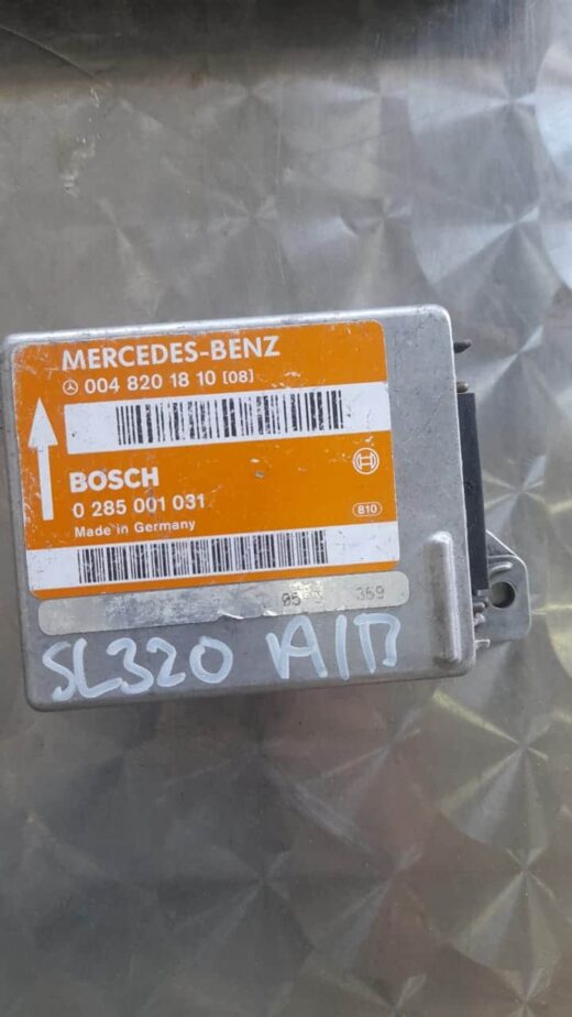 Mercedes Sl320 Air Bag Control Module 0048201810 Front view of a Mercedes SL320 air bag control module with wiring and mounting bracket visible.Front view of a