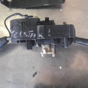 Front angle view of a Ford Telstar car combination switch stalk on a plain background.Front angle view of a Fo