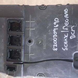 Front view of a new black Renault Megane Scenic body control module with visible connectors.Front view of a ne