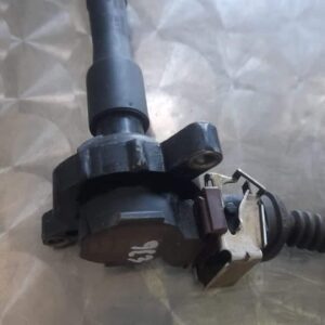 Front view of a BMW E36 coil showcasing its cylindrical shape and electrical connections as main image.Front v