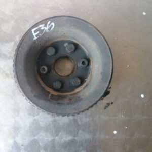 Front view of a used crank pulley for BMW E36 318 showing grooves and mounting holes.Front view of a used cran