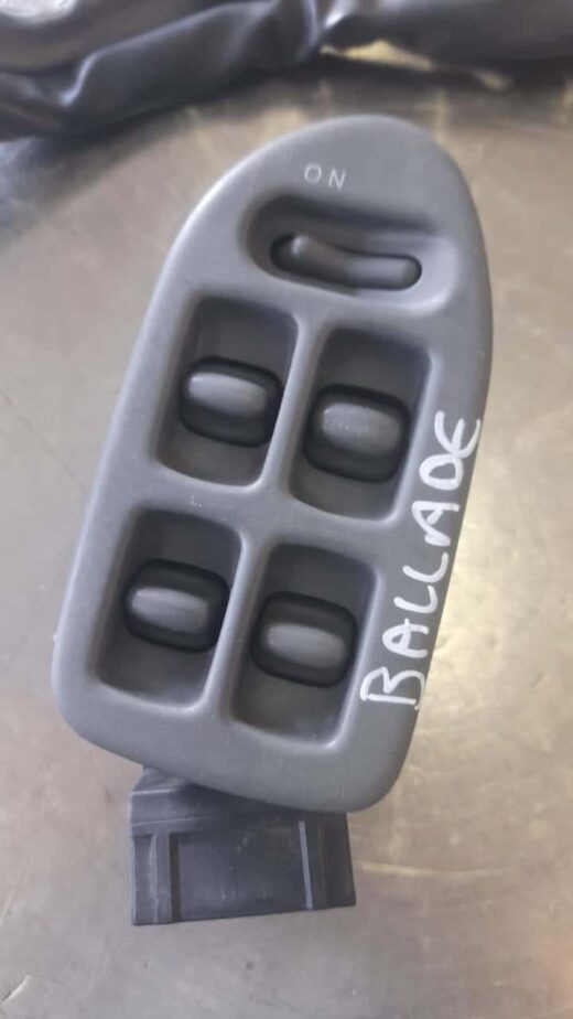 1994 Honda Ballade Main Window Switch Main front angle of a black car window control switch panel with four buttons and a lock button.Main front ang