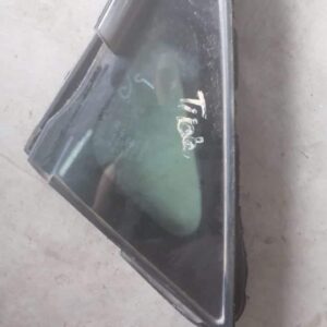 Left front quarter glass for Nissan Tiida, clear view angled from outside of the car.Left front quarter glass
