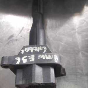 Used ignition coil for BMW E36, front-side angle showing mounting points and electrical connector.Used ignitio