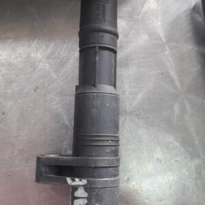 Used ignition coil viewed from the side showing electrical connectors and mounting points.Used ignition coil v