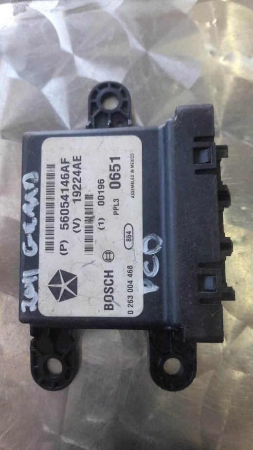 2012 Jeep Grand Cherokee Pcd Module 56054146Af Front view of a PCD module for Jeep Grand Cherokee showing connectors and wiring in featured image.Front view