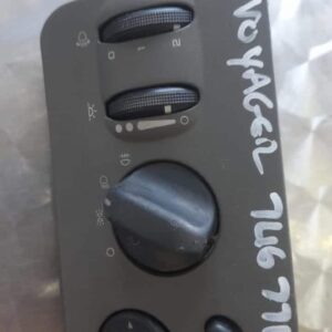 Front view of a Chrysler Voyager headlight switch with rotary dial and indicator markings.Front view of a Chry