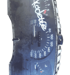 Front-facing view of a car instrument cluster featuring speedometer, tachometer, and gauges.Front-facing view