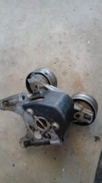 Front angled view of a new Ford Ranger WL 2.5 tensioner pulley showing pulley and mounting bracket.Front angle