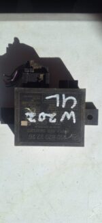 Top-down view of a Mercedes W210 central locking control unit with wiring and connectors visible.Top-down view