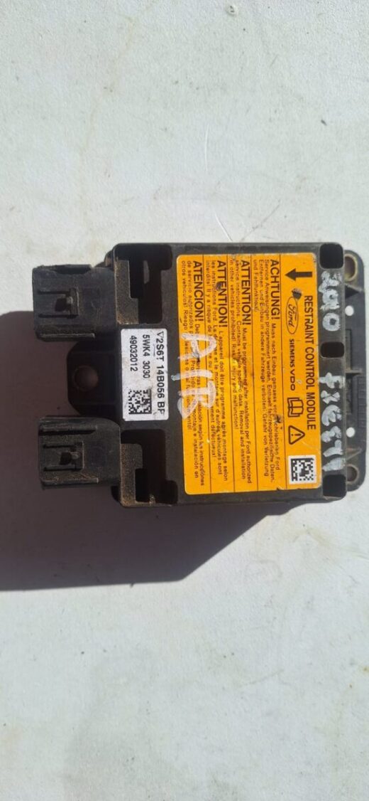 Front angle view of a Ford Fiesta MK6 airbag control unit showing electronic components and connectors.Front a