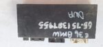 Close-up of BMW car alarm control unit showing front and side with wiring connectors.Close-up of BMW car alarm