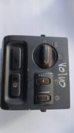 Close-up angled view of a Volvo headlight switch showing control knob and mounting bracket.Close-up angled vie