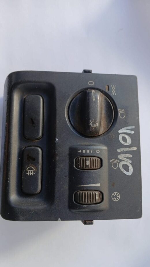 Close-up angled view of a Volvo headlight switch showing control knob and mounting bracket.Close-up angled vie