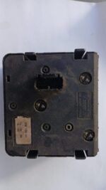 Close-up of a Volvo headlight switch from a slight top angle, showing the control knob and indicator markings.