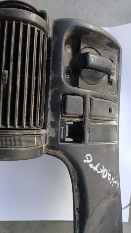 Front view of a 1995 Opel Kadette headlight switch and cover assembly on a white background.Front view of a 19