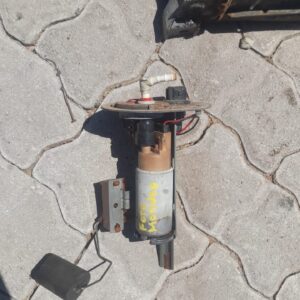 Close-up of a car fuel pump viewed from the side, showing connectors and mounting points.Close-up of a car fue