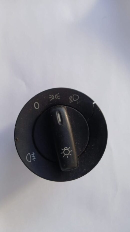 Used VW Polo headlight switch shown from front angle with visible control knob and markings.Used VW Polo headl