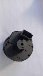 Close-up front view of a used VW Polo headlight switch showing its control knobs and mounting points.Close-up
