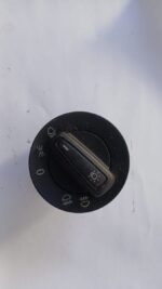 Close-up of a VW Polo headlight switch showing the control knob and mounting base from the front angle.Close-u