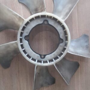 Used radiator fan blade shown from top angle with visible mounting hub and blades.Used radiator fan blade show